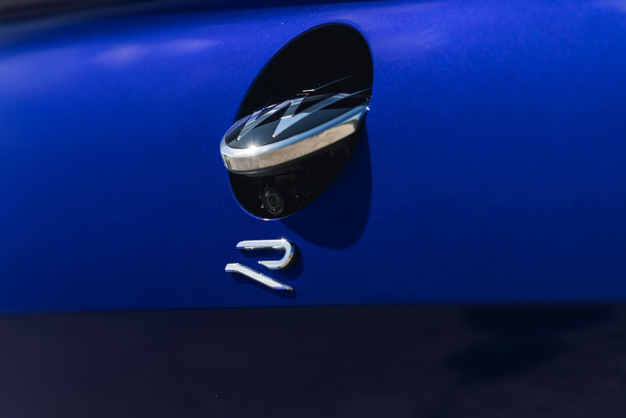 Close Up of the R Badge on the Back of a Blue Shooting Brake